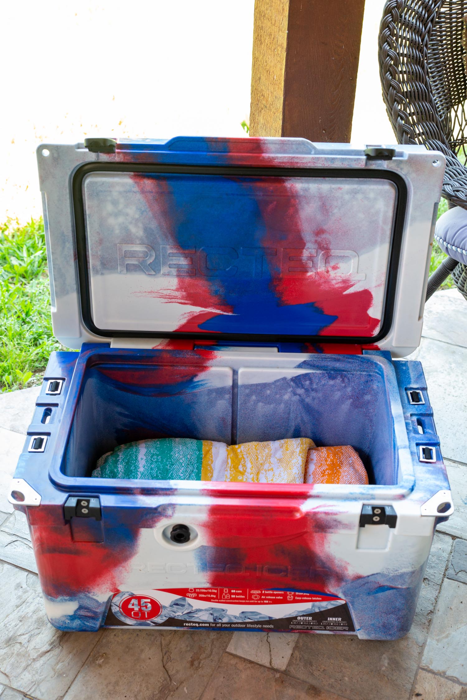 Brisket wrapped in a towel, resting in a cooler