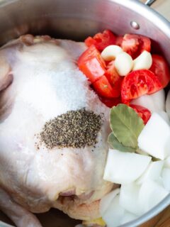 A large pot of chicken and vegetables before cooking