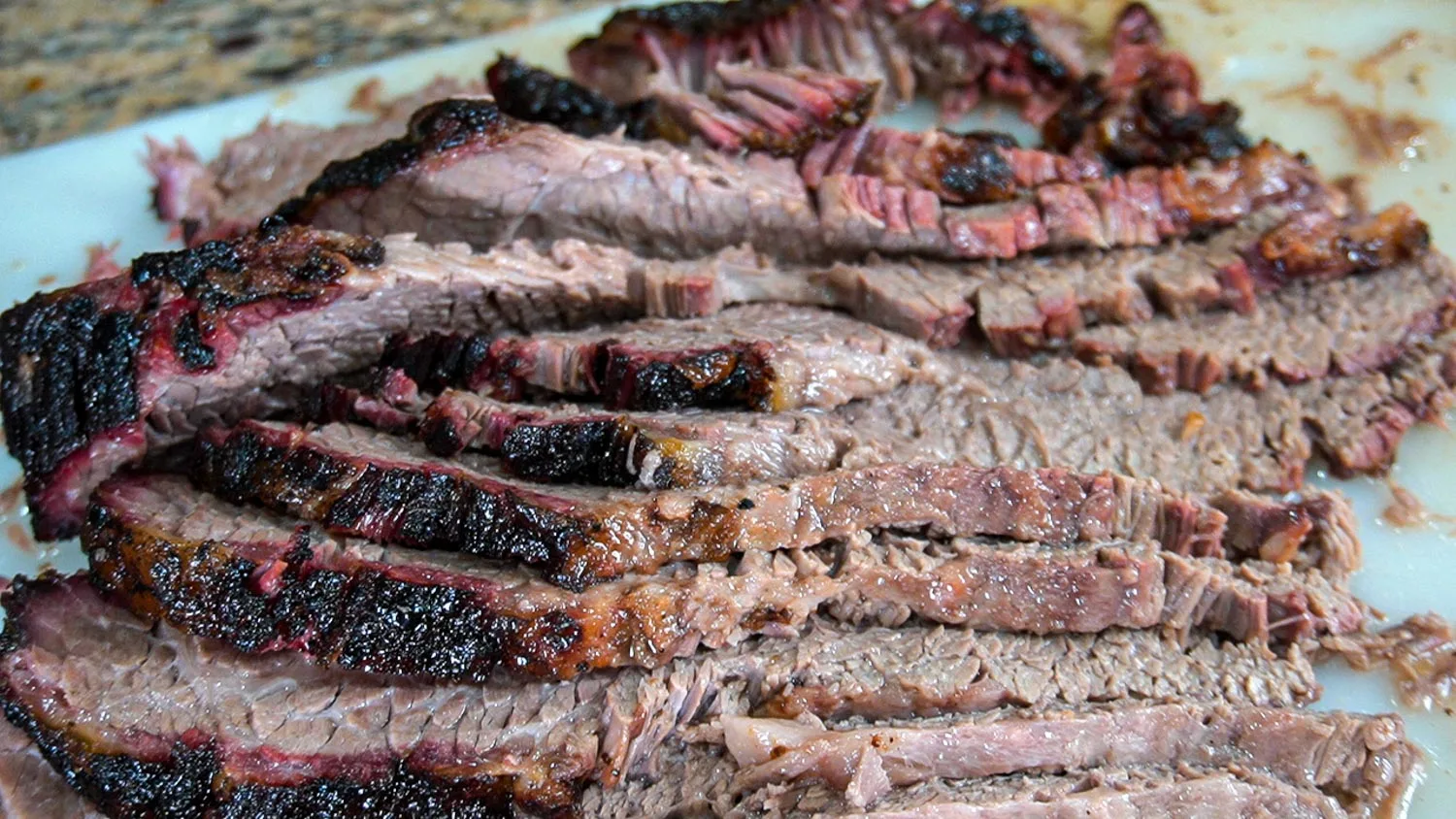 A close up of juicy sliced barbecue brisket, with a nice bark. 