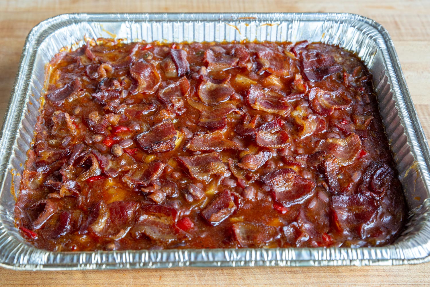 An aluminum pan of smoked beans