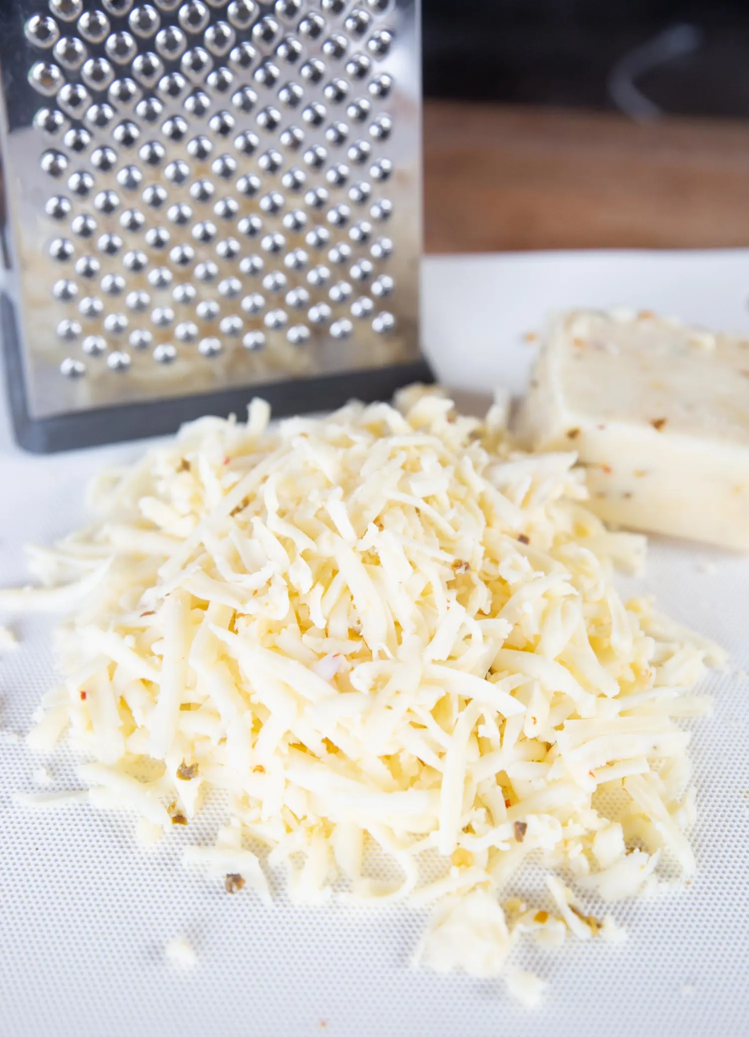 grated pepper jack cheese on a cutting board