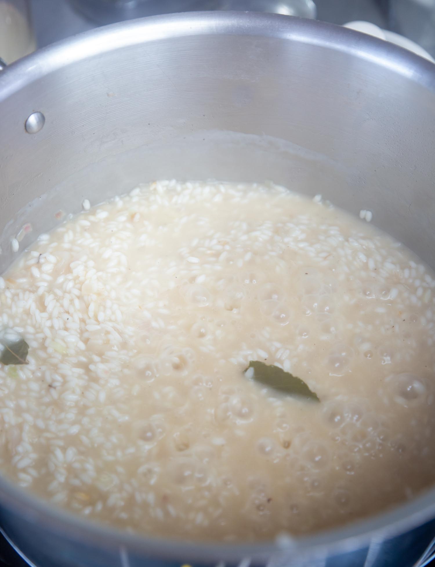 Chicken stock slowly cooking the rice and melting and thickening into a wonderful, creamy sauce.