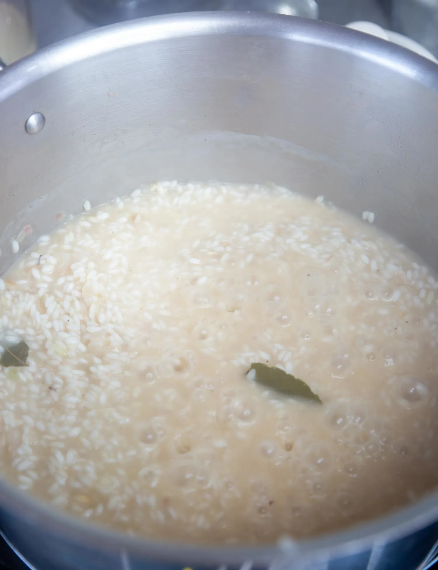 Chicken stock slowly cooking the rice and melting and thickening into a wonderful, creamy sauce.