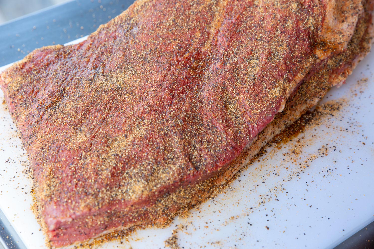 A raw beef brisket covered with our rub.