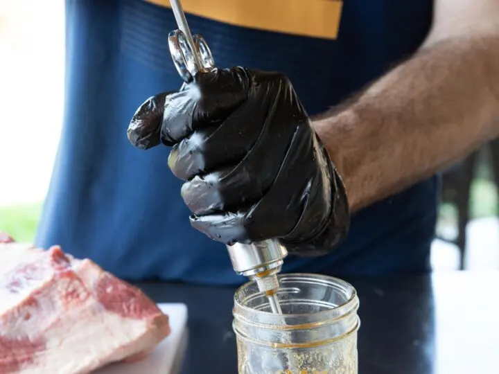 A man pulling the injection into a syringe.