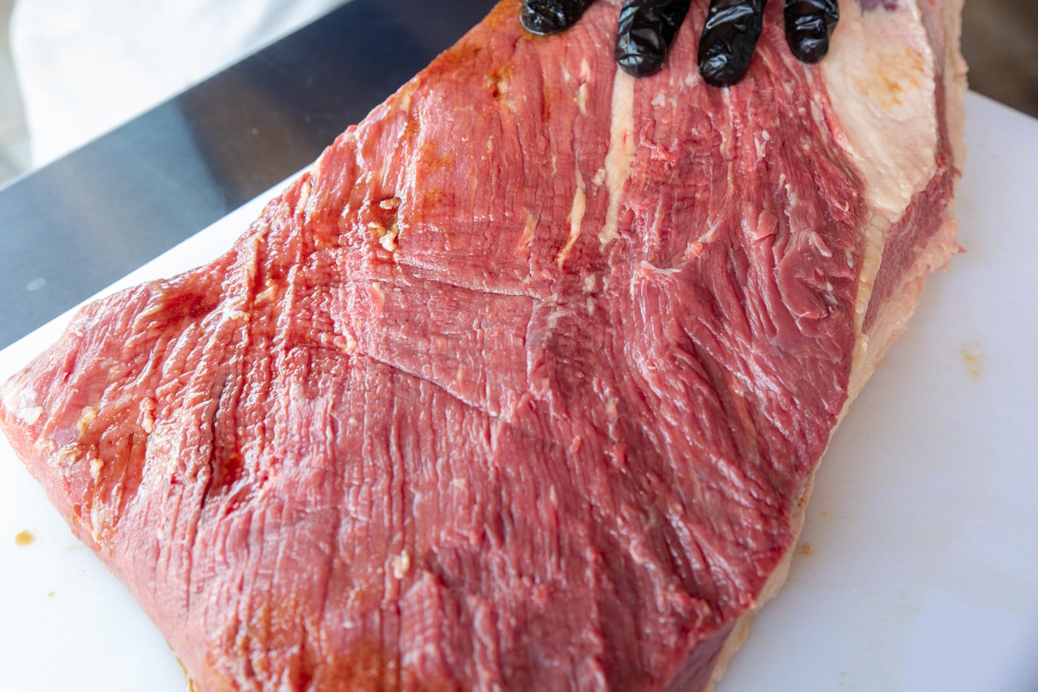 a brisket with a bit of liquid leaking from the holes. this is normal.