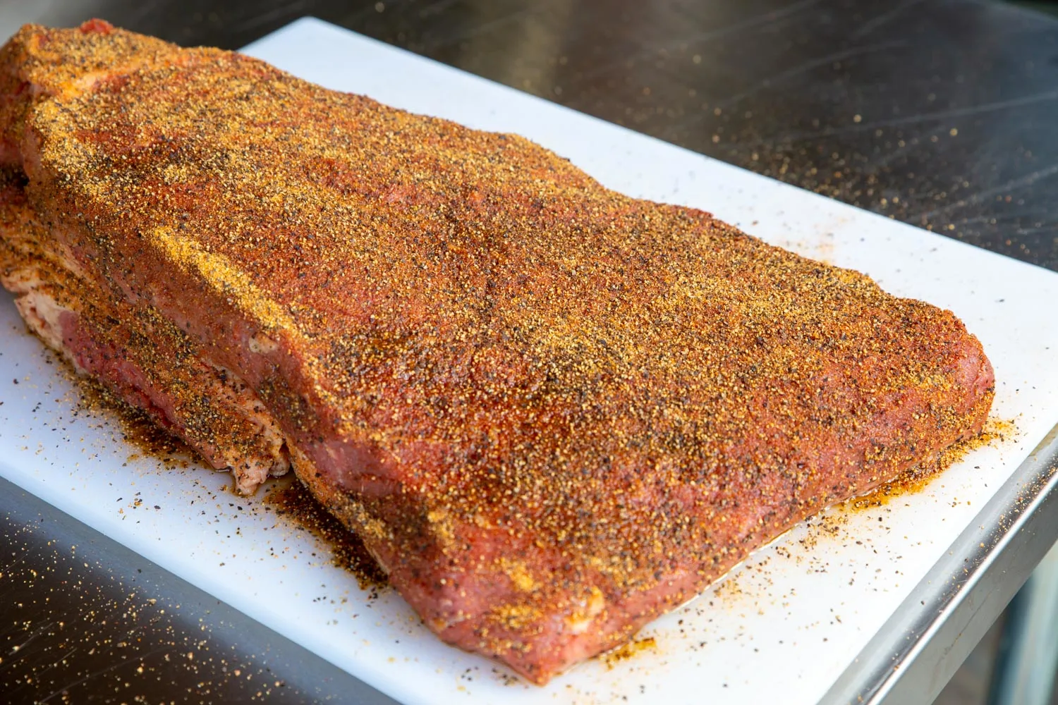 A brisket with dry rub sprinkled on correctly