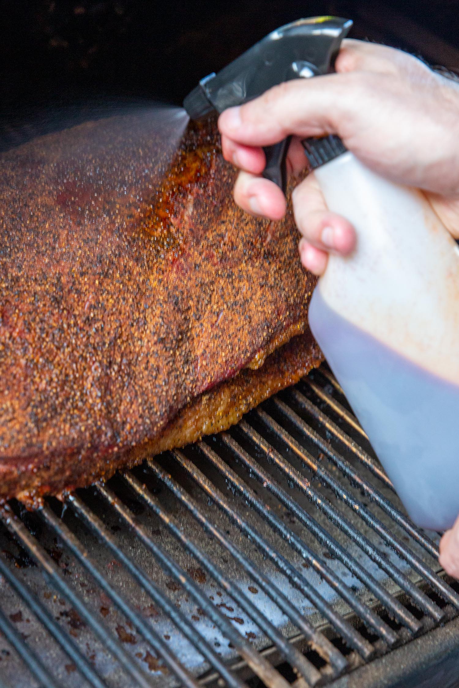 spritizing a brisket with brisket spray