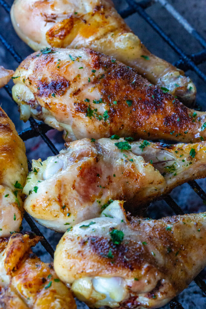 chicken legs barbecuing on the grill