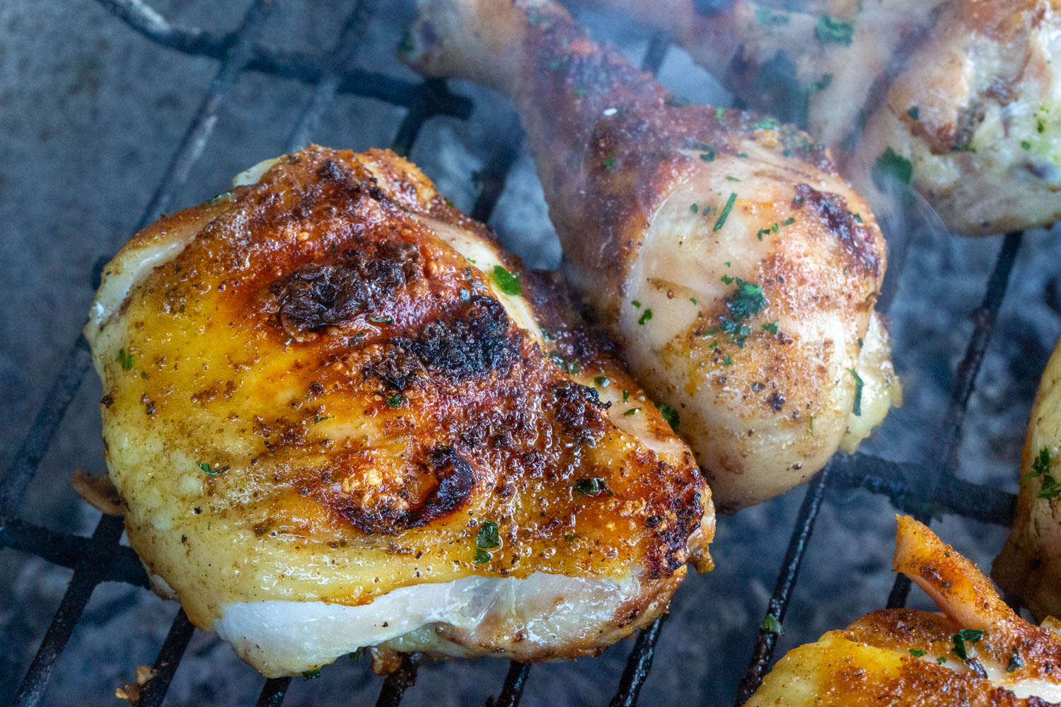 a chicken thigh over charcoal