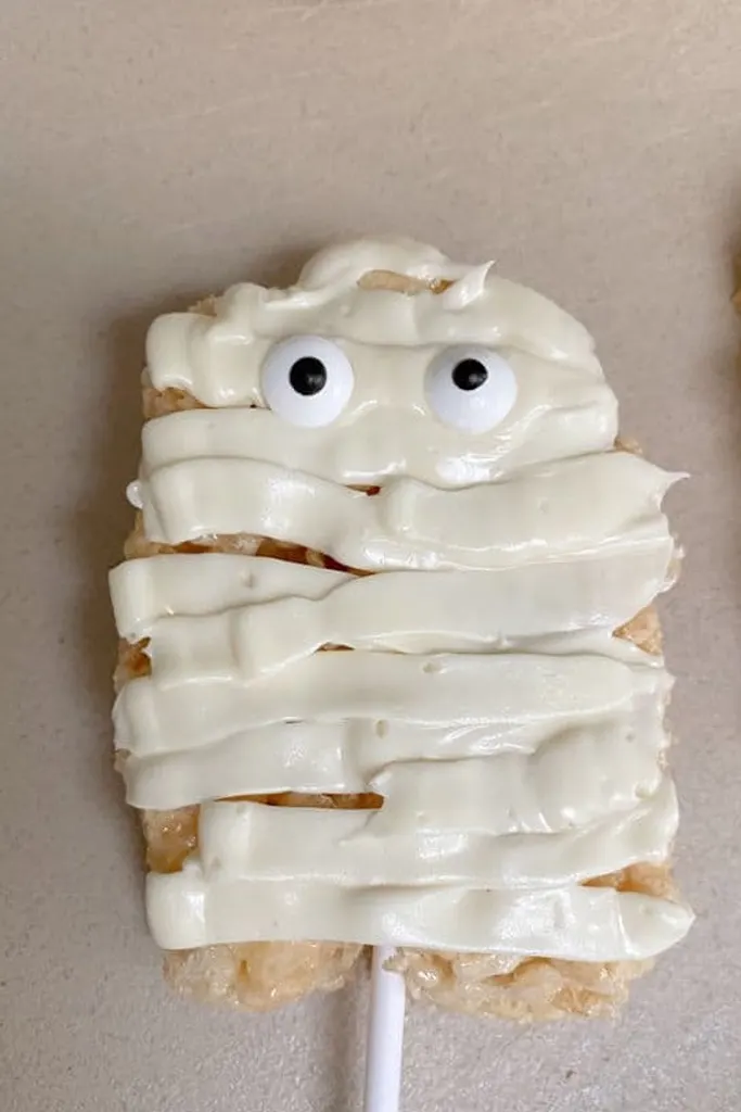 little white mummy cookies on a stick