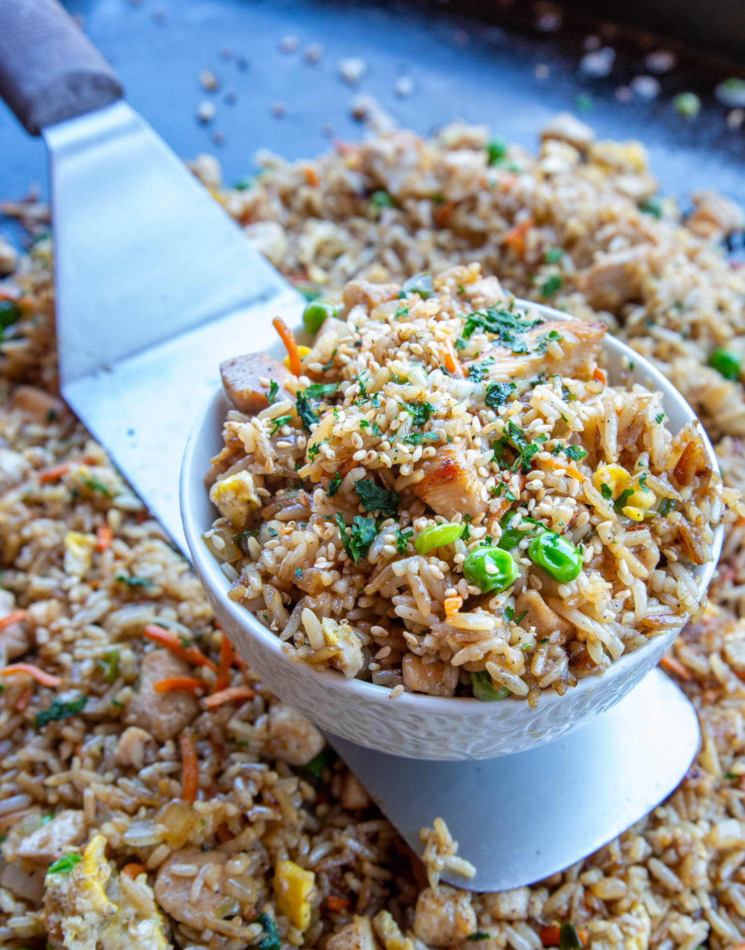 chicken fried rice in a bowl over the griddle surface