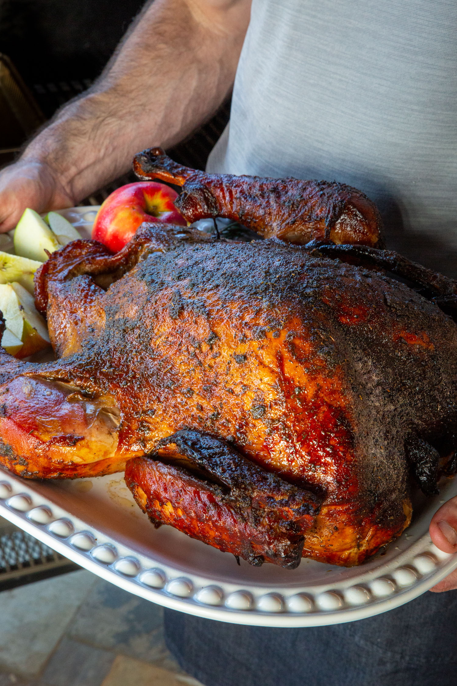 Turkey smoked on a pellet smoker on a white platter