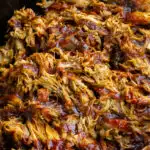 Pulled pork in a crock pot with barbecue sauce
