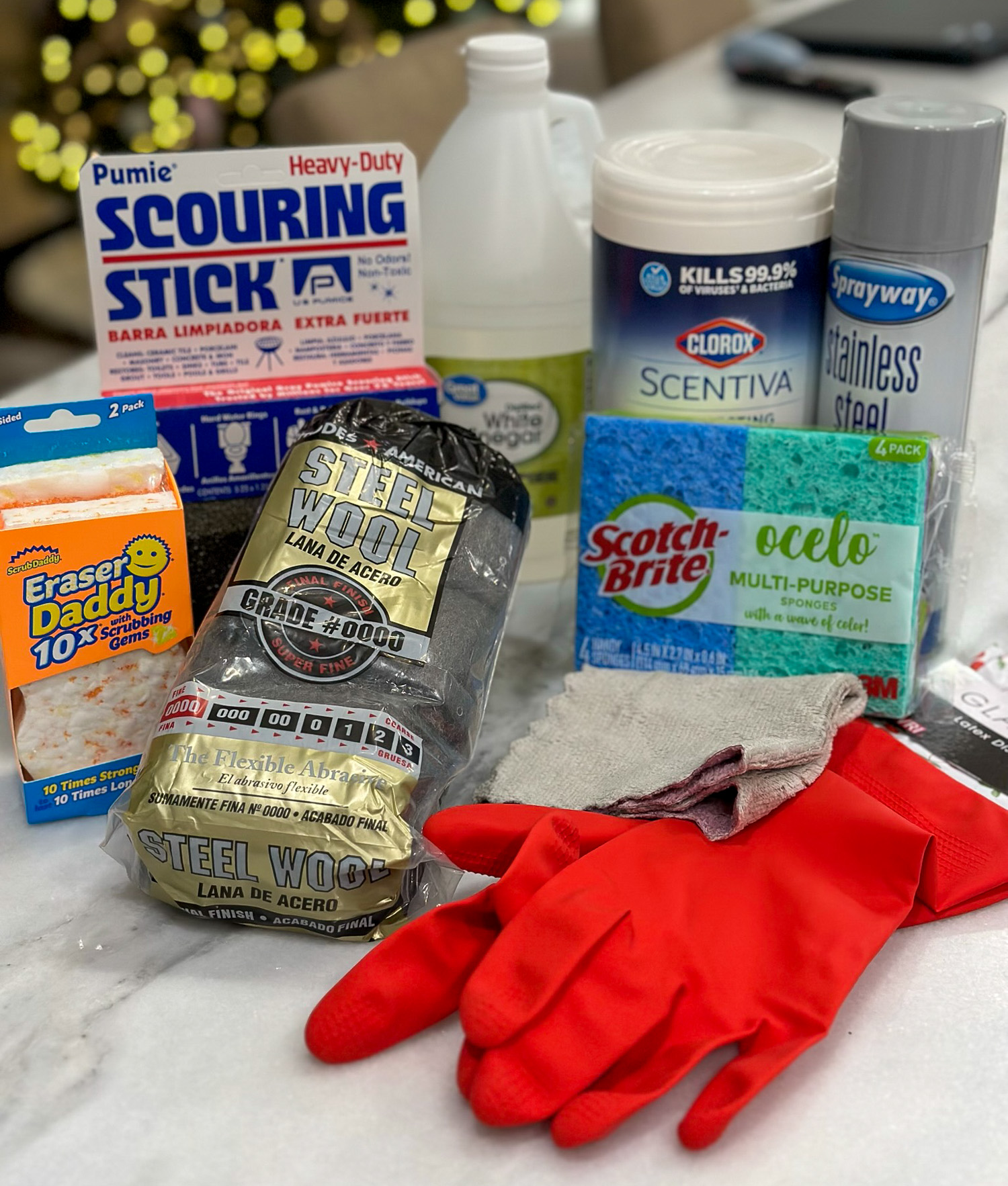 Various cleaning products for cleaning the Blackstone Griddle - grill stone, white vinegar, steel wool, gloves, sponges.