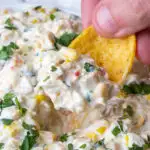 corn dip being scooped with a frito dip