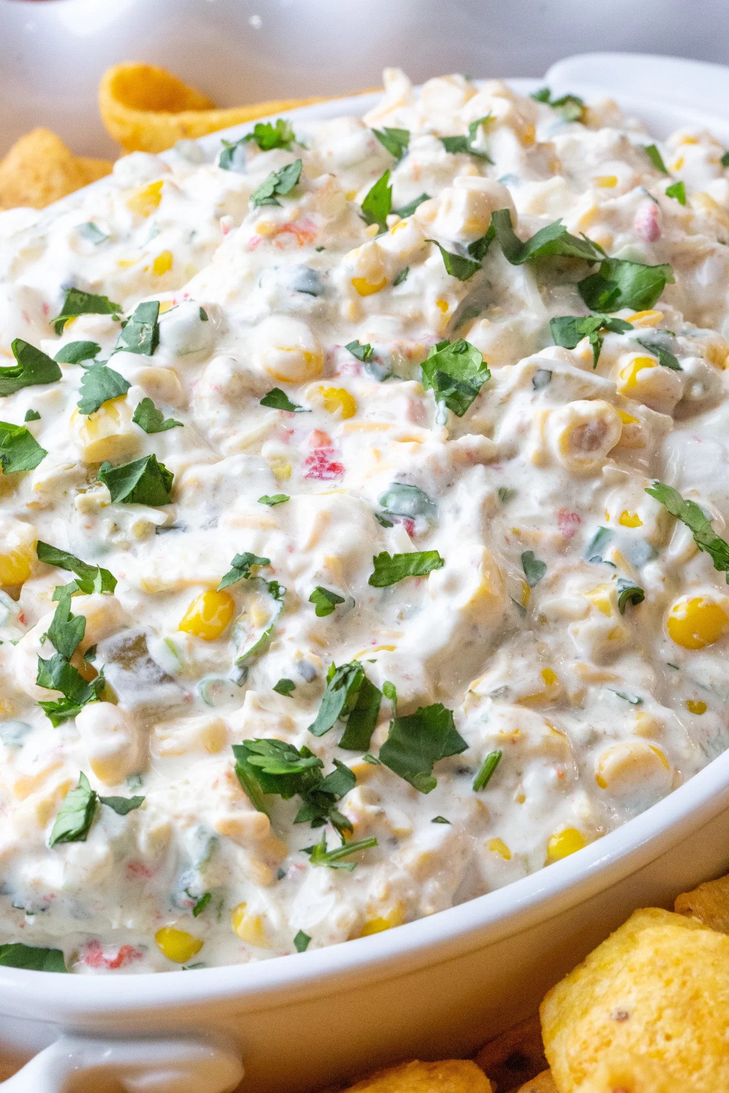 close up of a bowl of corn dip in an attractive bowl.