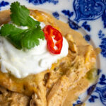 A close up of the layered low carb tortillas, tender chicken, and sour cream from this keto casserole.