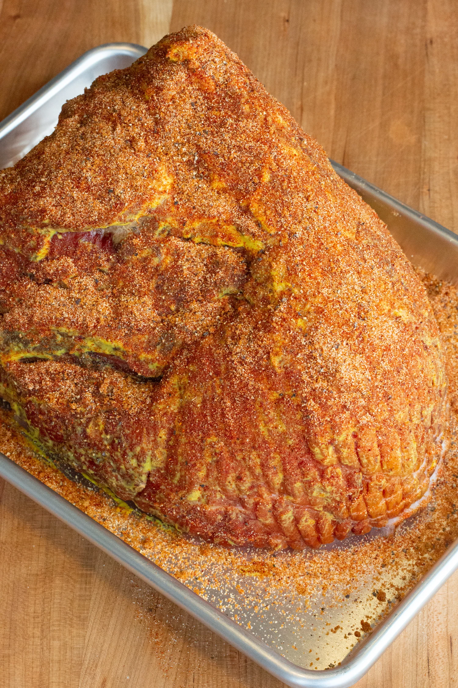 a ham coated with mustard and ham rub