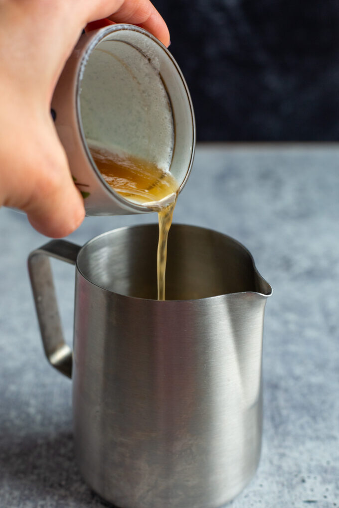 pour coffee syrup into the pitcher with the heavy cream