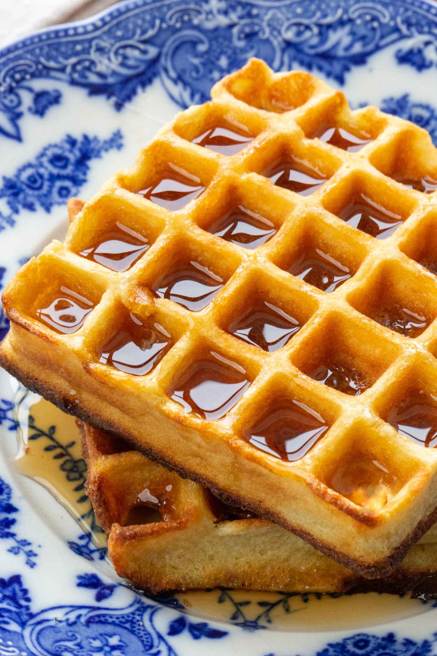 A close up of a low carb waffle on a blue plate.