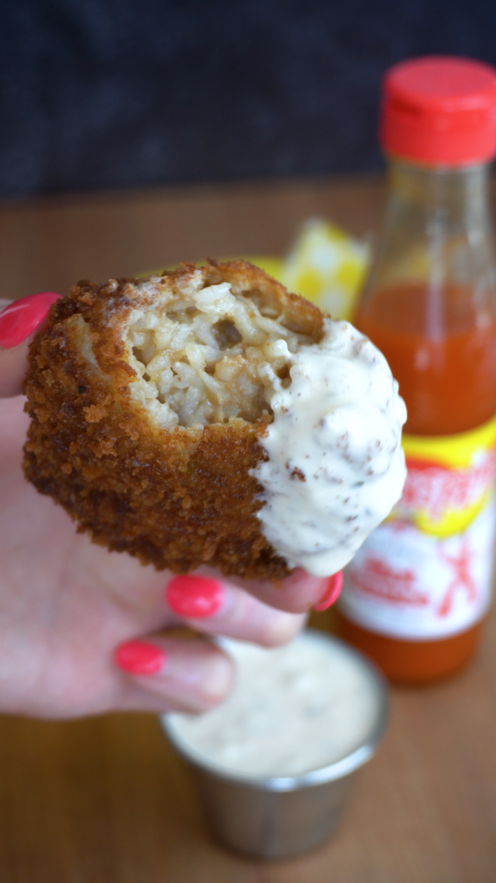 A fried gumbo ball dipped in ranch dressing