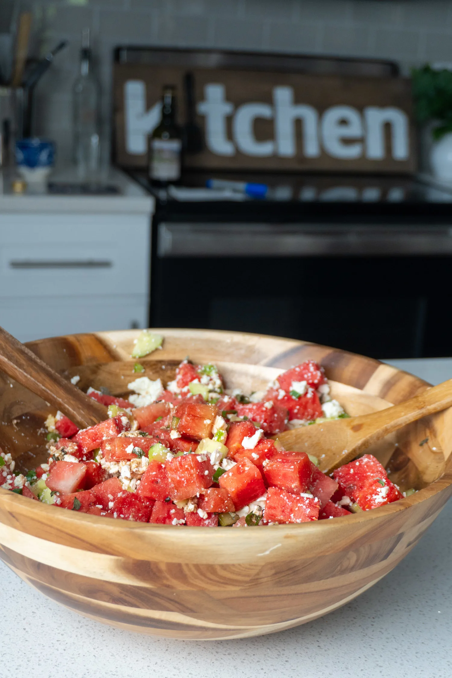 A bowl of watermelon salad on a countertop in the test kitchen