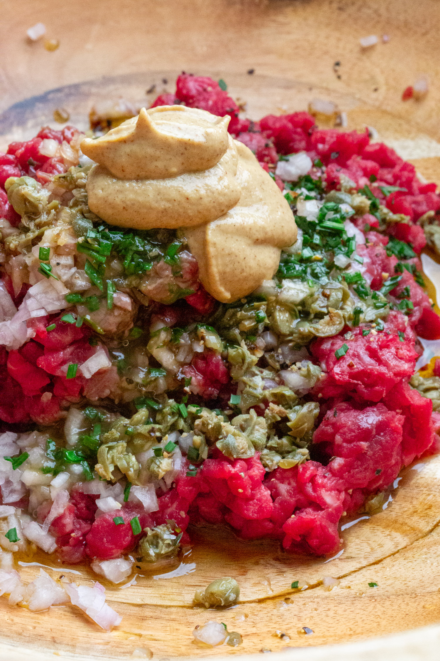 a bowl of beef tartar ingredients using the best cut