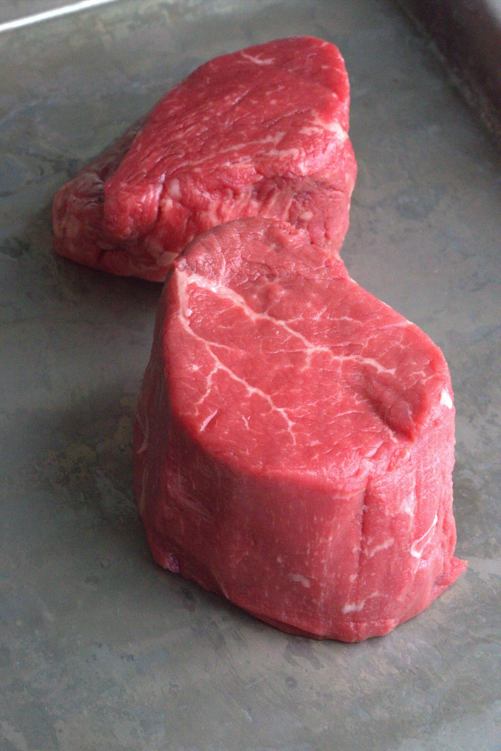 filet mignon steaks on a baking sheet (raw)