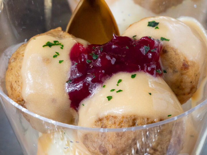 An upclose shot of a cup of ikea swedish meatballs made as a miniature appetizer.