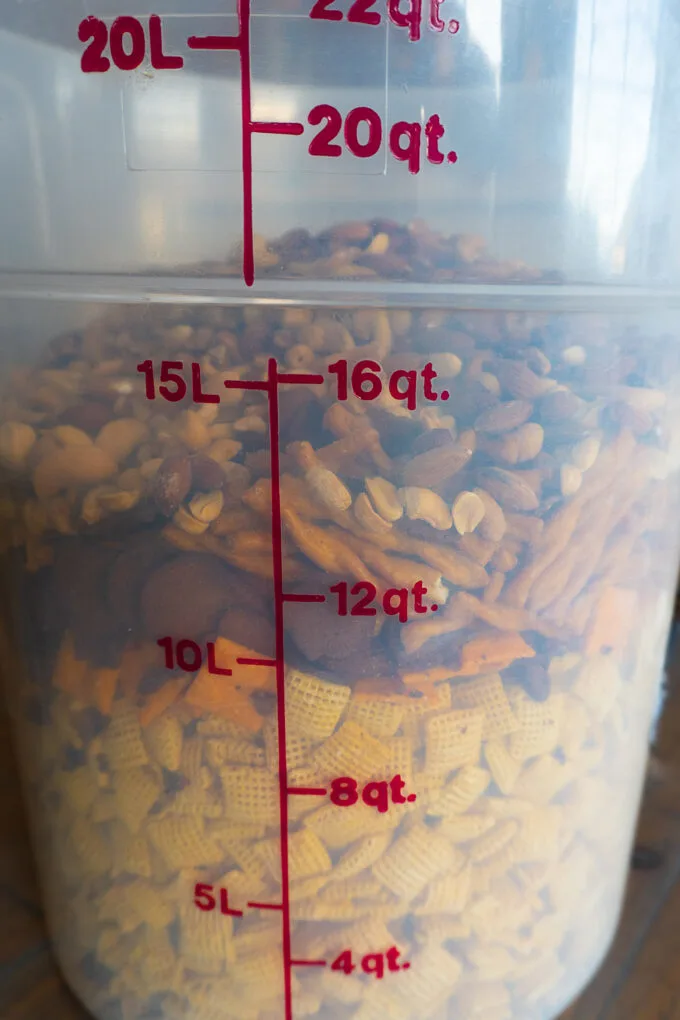 large vessel filled with chex cereal, pretzels, crackers, and nuts