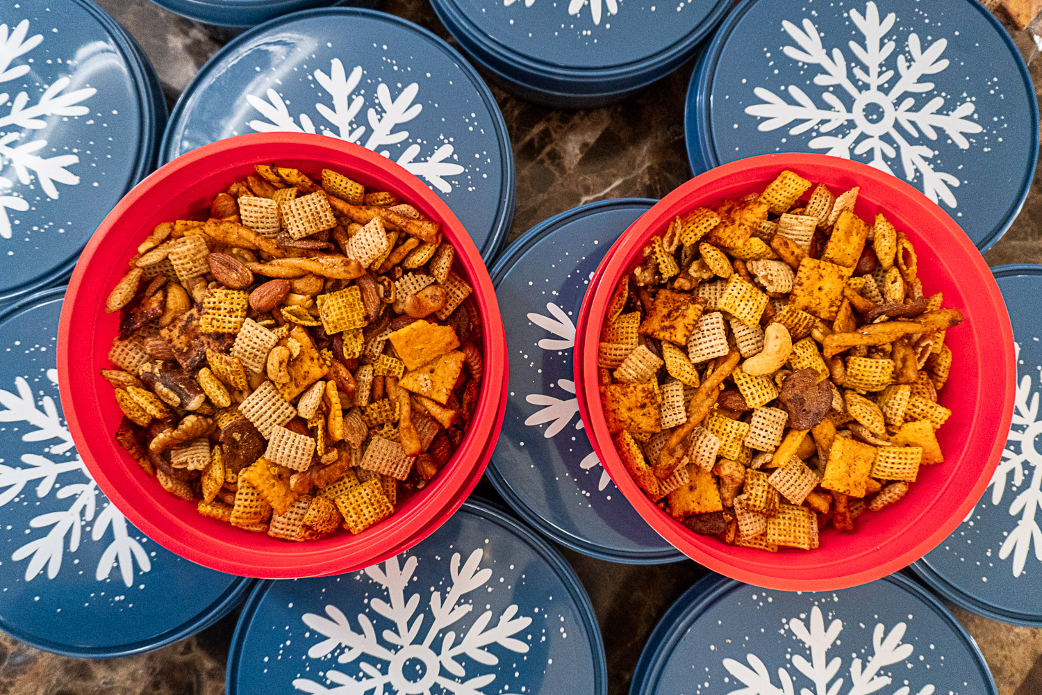 Smoked chex mix in brightly colored containers for gifting.