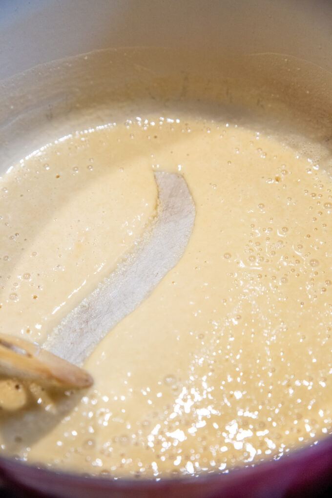 Stirring the blonde roux until creamy and it begins to drag.