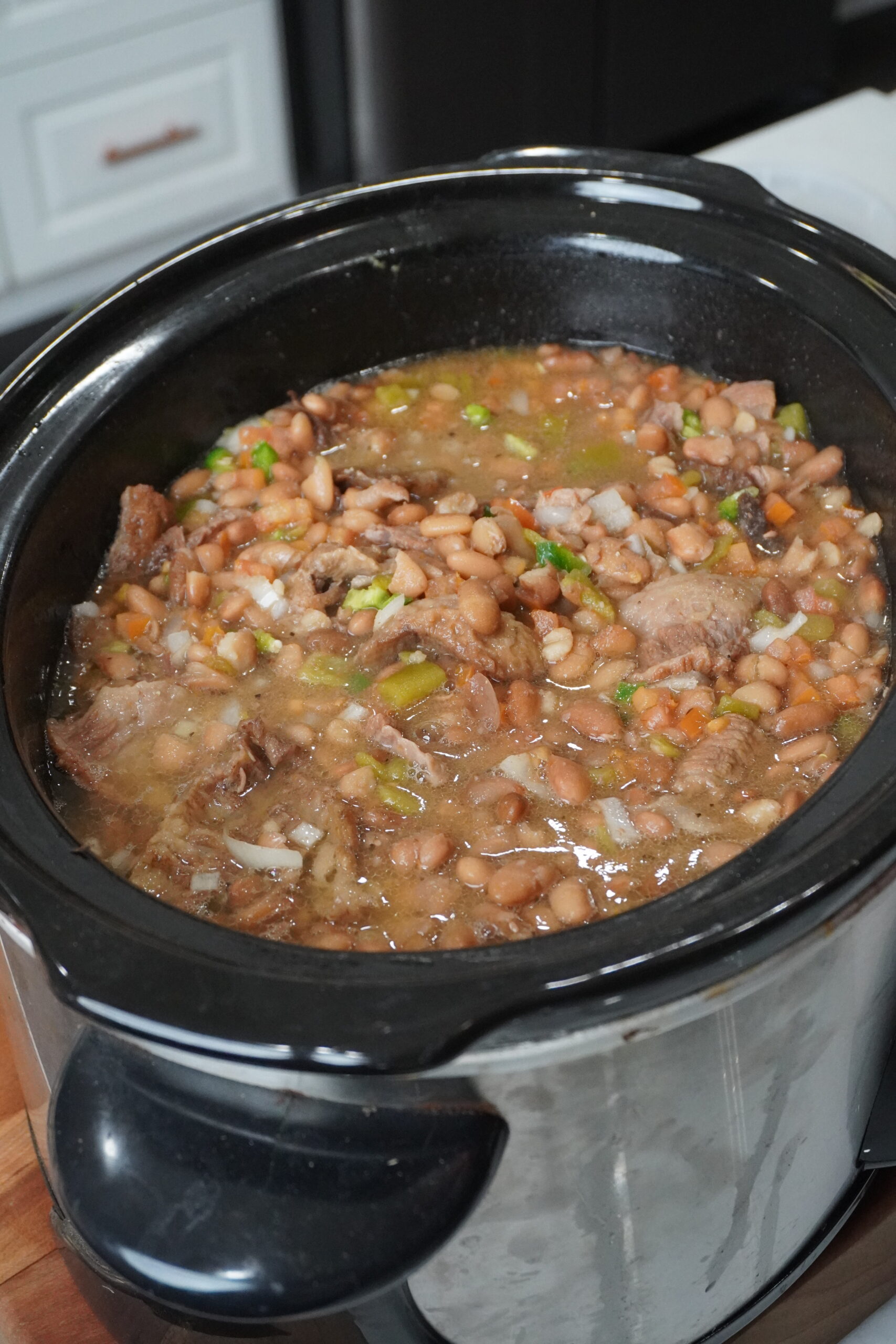 a slow cooker full of brisket beans
