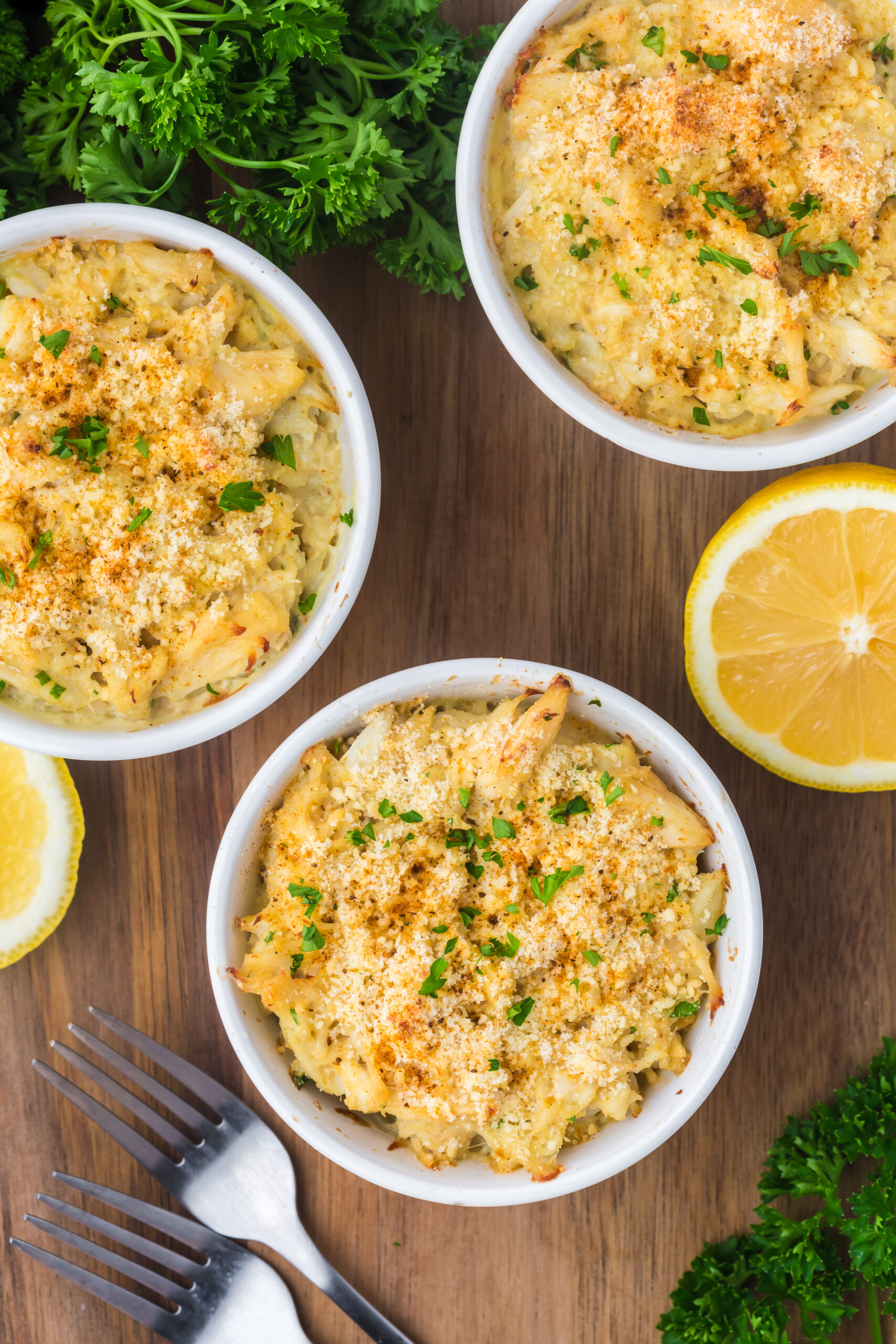 a birds-eye view shot of three ramekins full of baked crab imperial