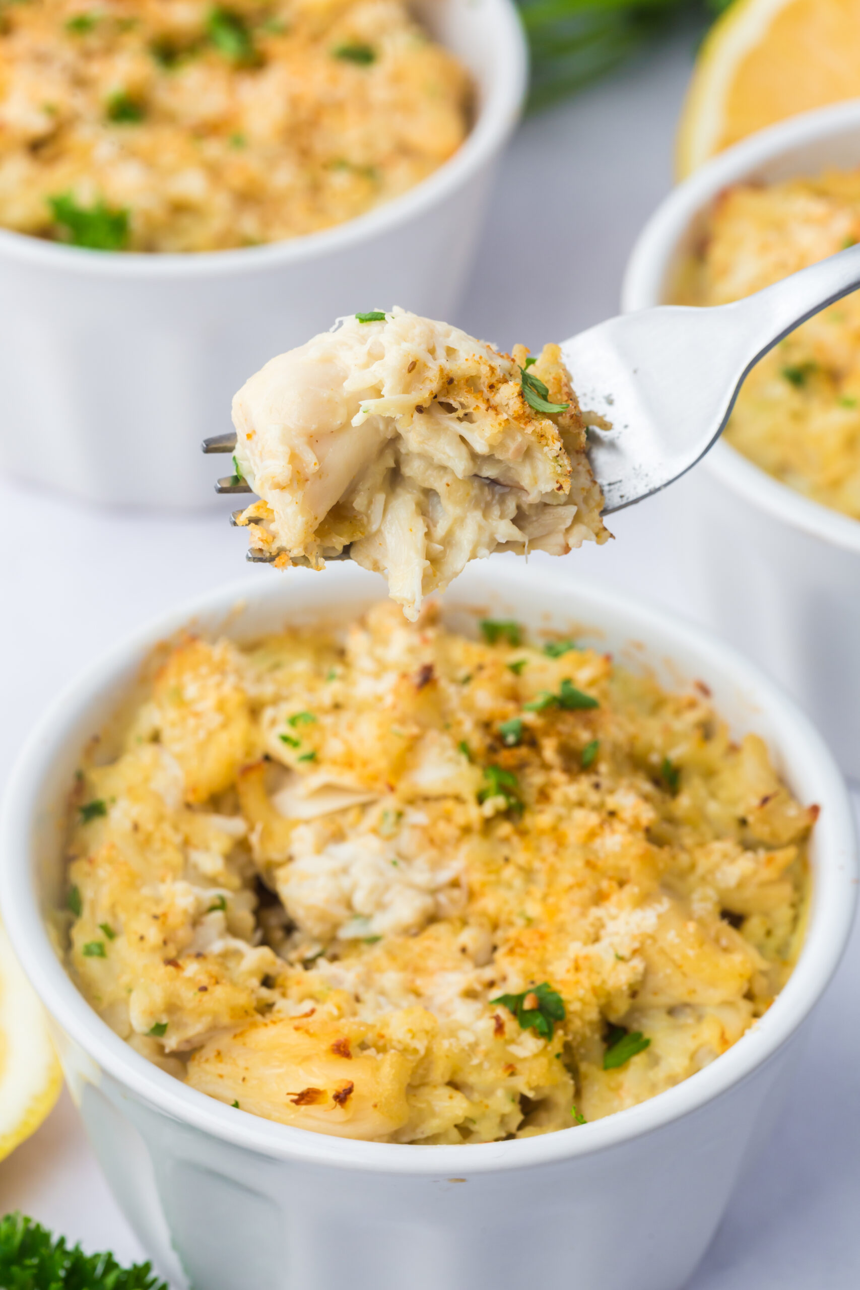 A fork scooping up a bite-size portion of Crab Imperial