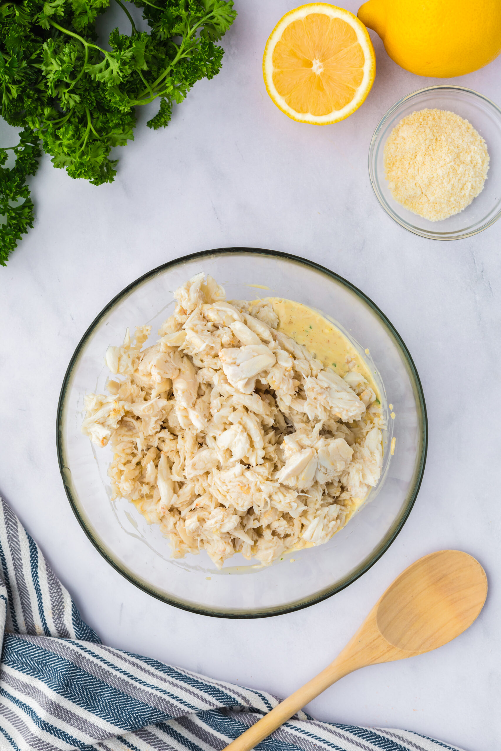 crab meat placed on top of the imperial sauce in a shallow bowl