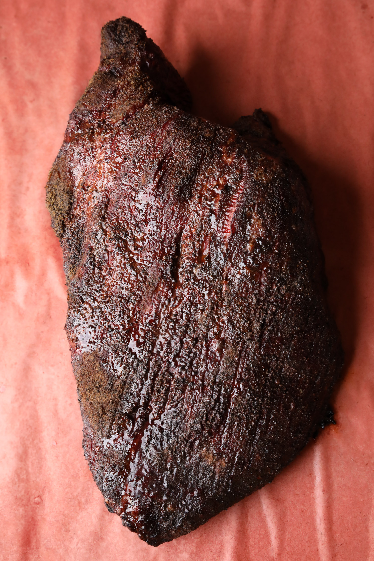 a fully smoked and uncut Brisket on top of butcher paper