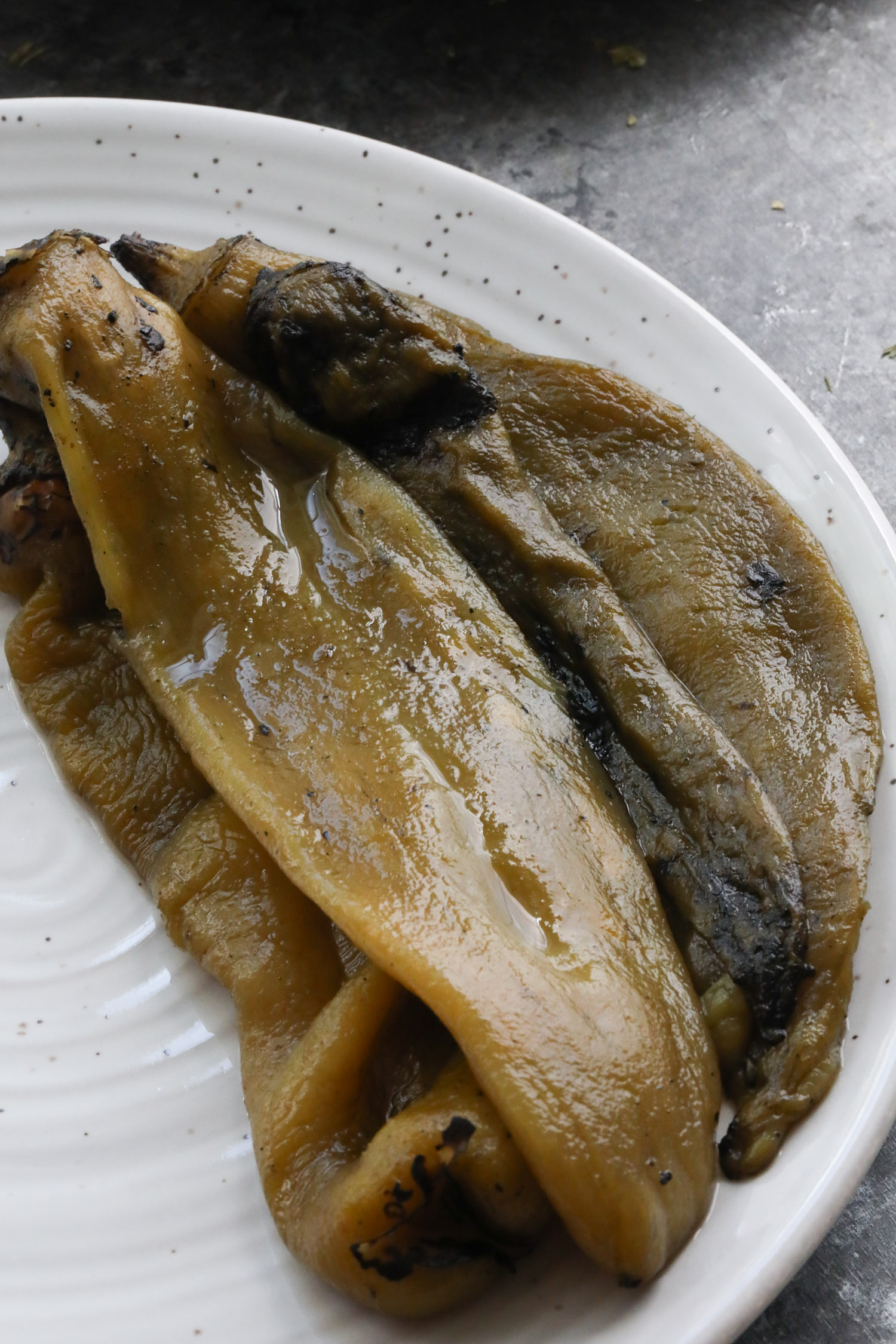 roasted hatch green chiles laying on a white plate