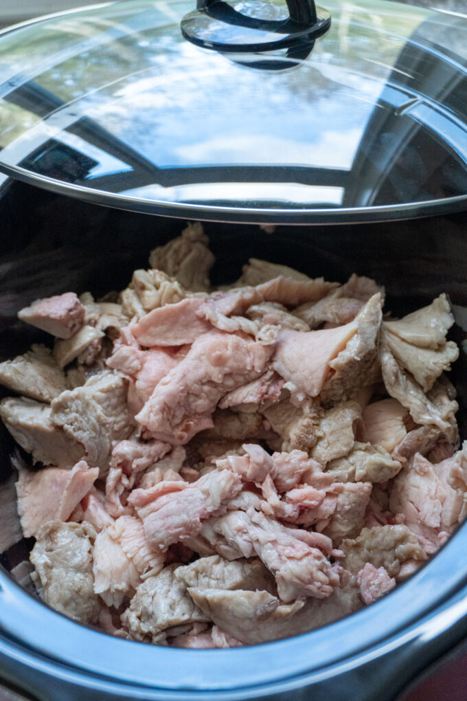 A slow cooker full of fat trimmings