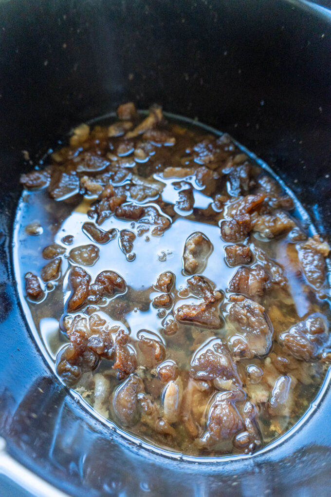 The same trimmings reduced down into liquid fat with cracklings rising upon the surface of the tallow.
