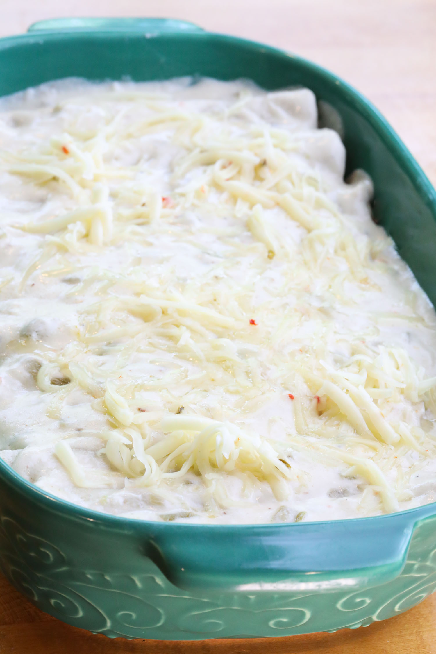 The casserole dish is now covered in sauce and topped with cheese