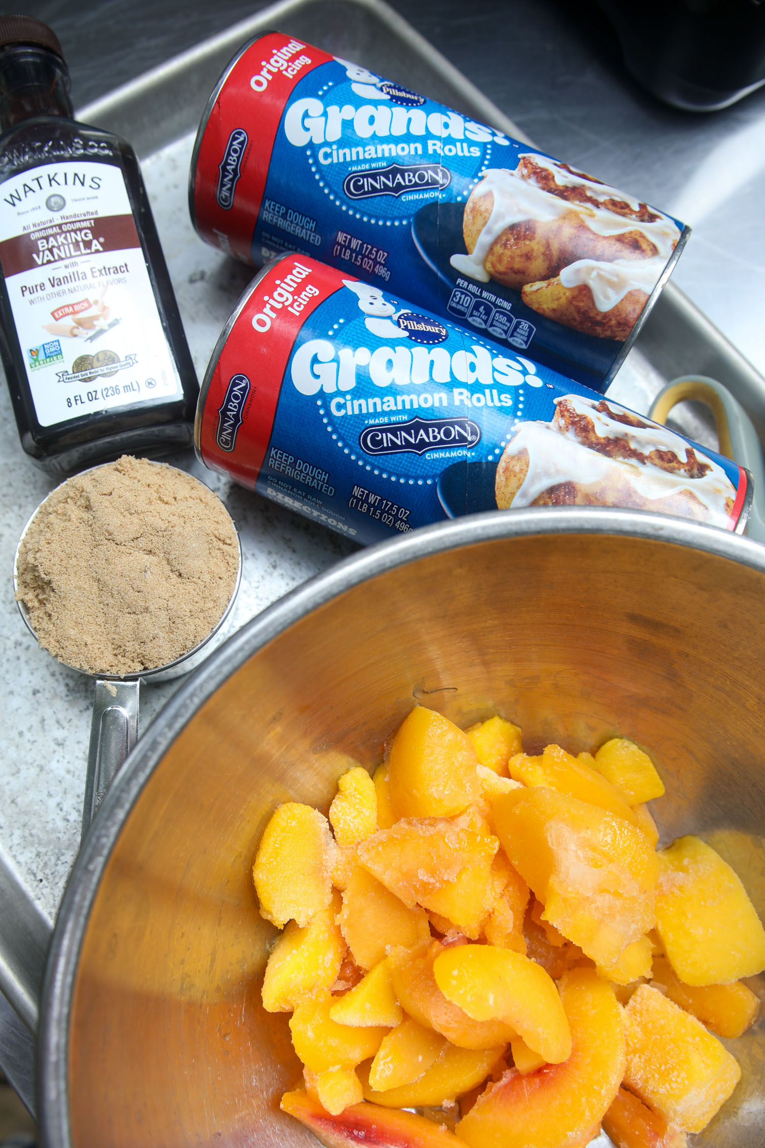 All of the ingredients for this cinnamon roll bake with peaches