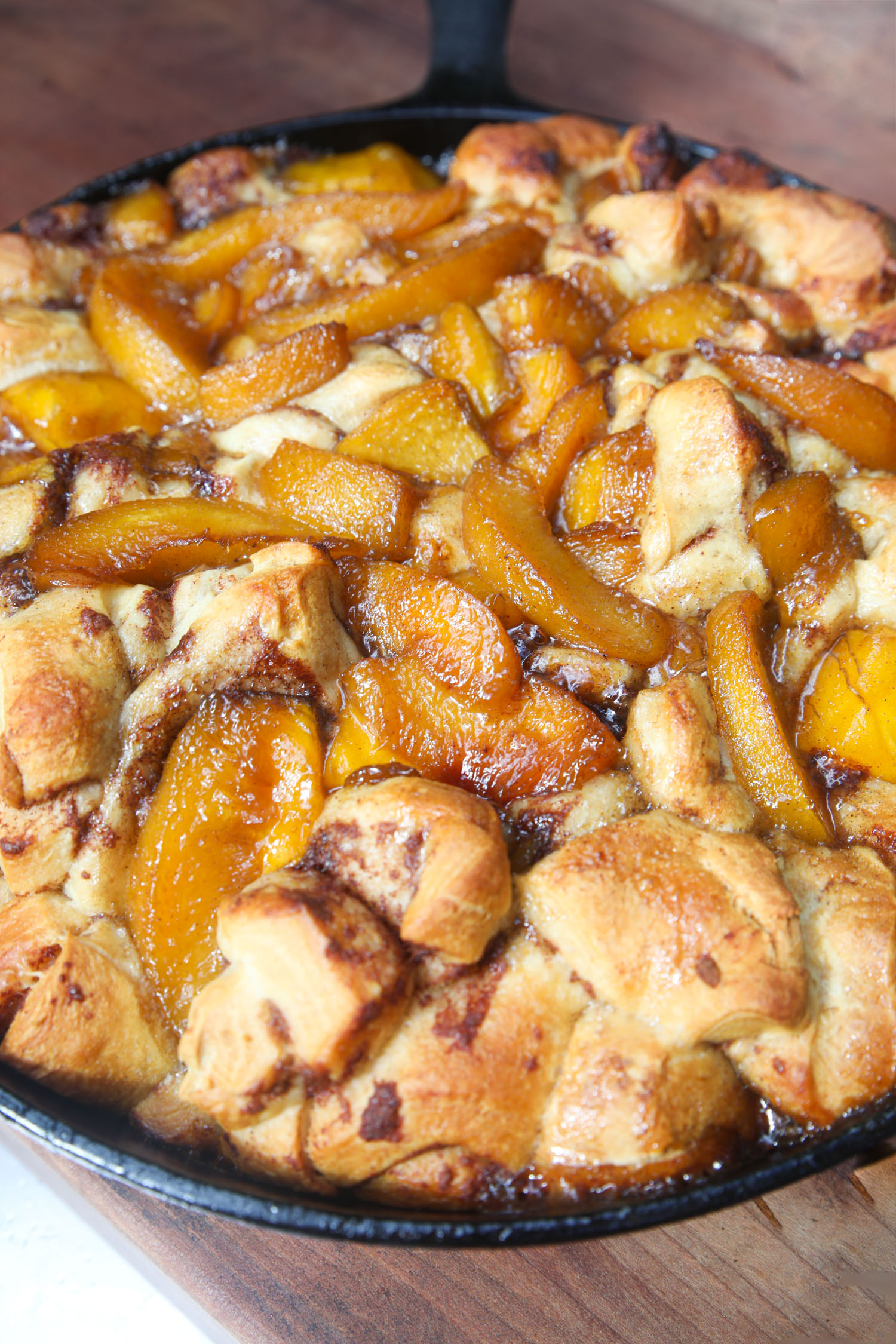 The cinnamon roll bake completed, cooked in a pan.