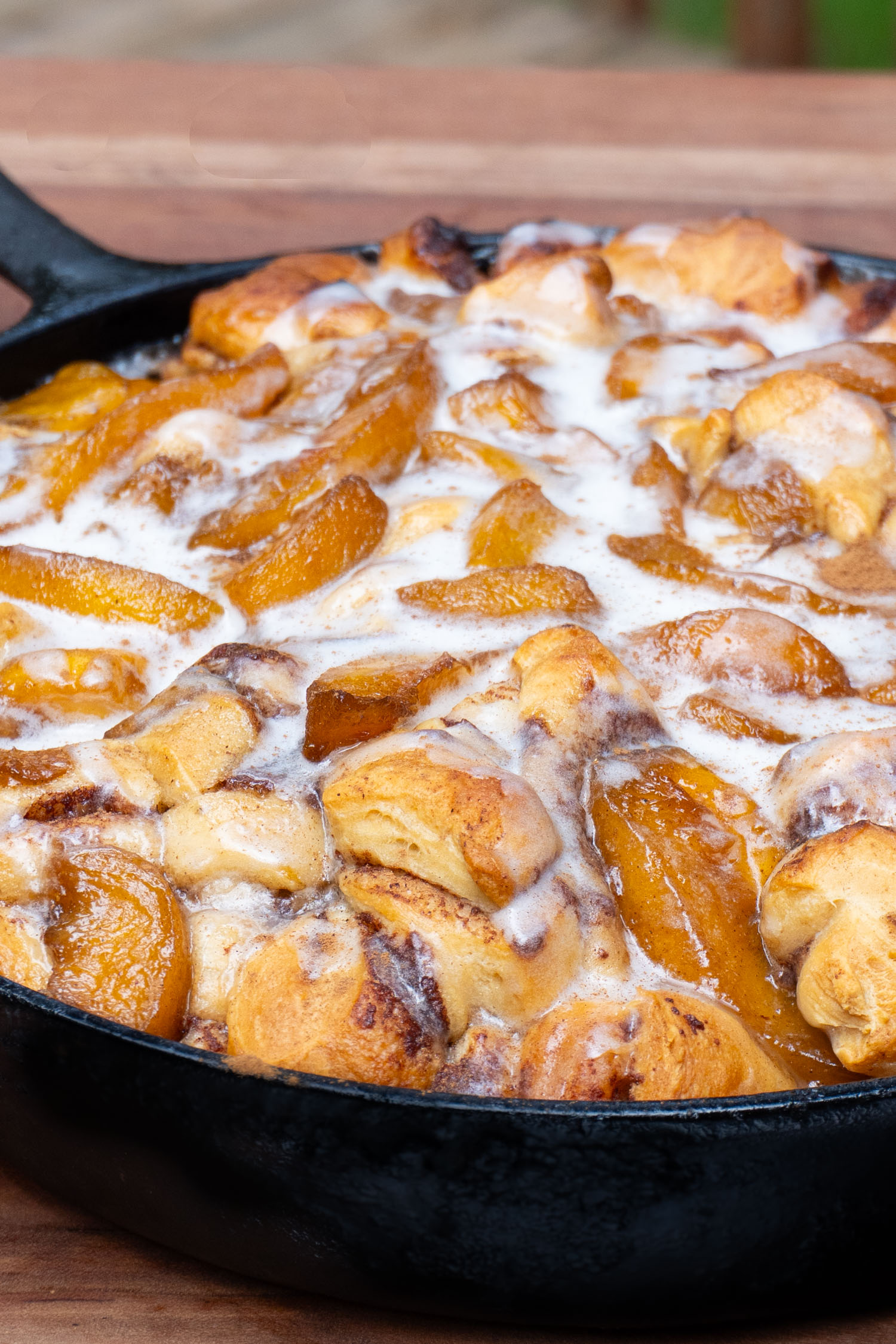 a close up of the cinnamon roll bake topped with icing