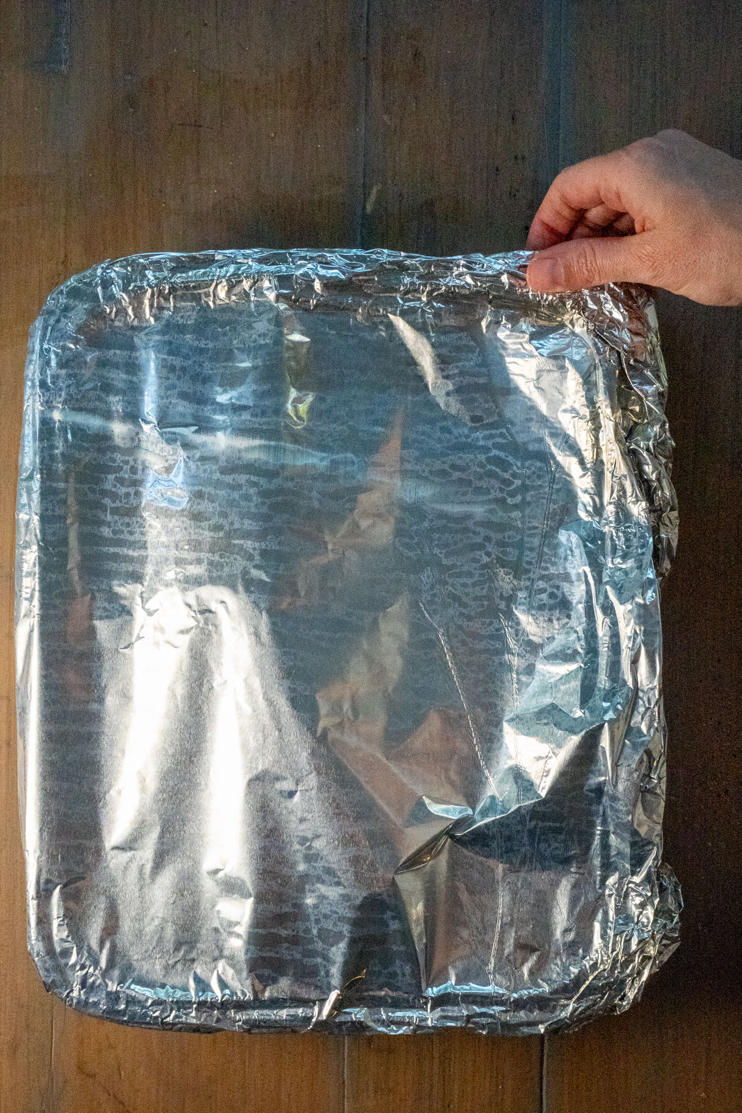 A foil pan covered in aluminum foil, ready for the roasting portion of the cook