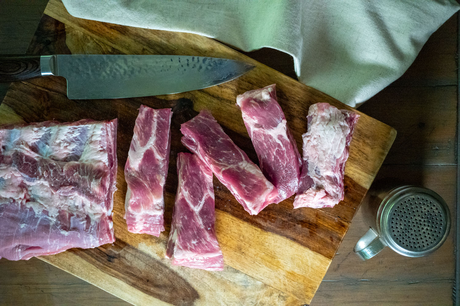 A cutting board full of ribs cut into individual pieces