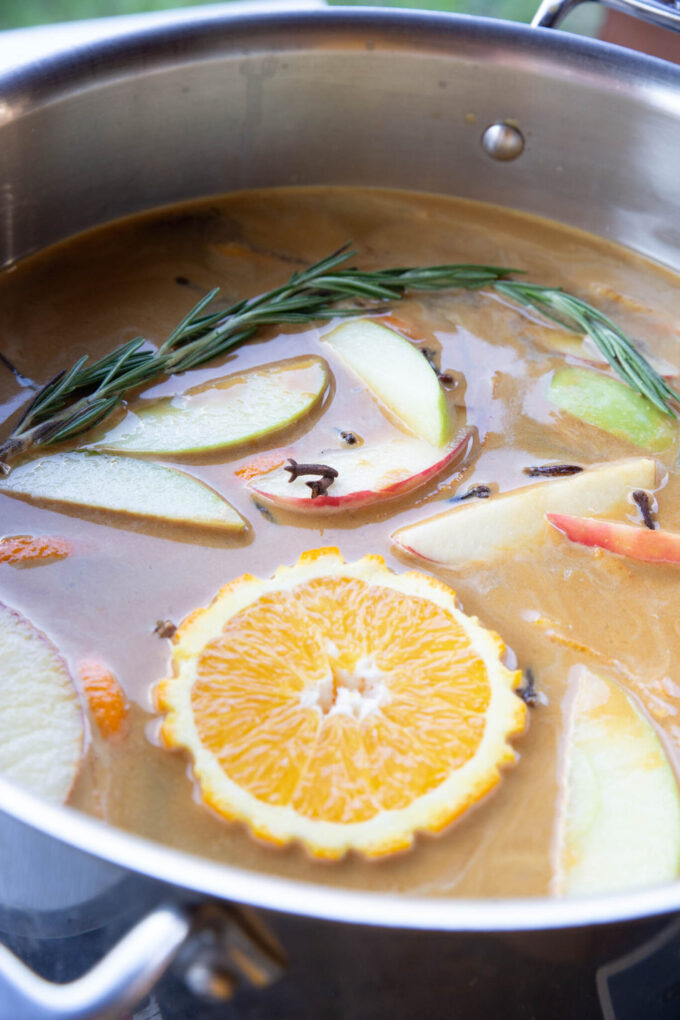 Brewing the fruit and cider with herbs.